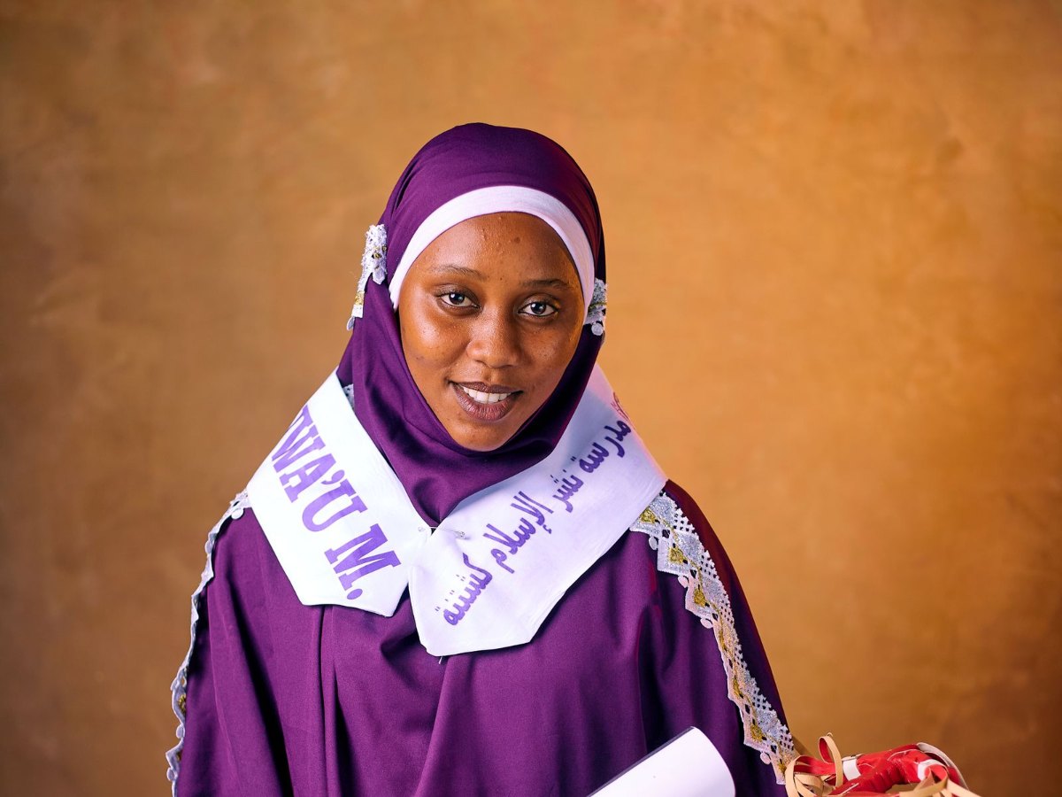 Woman in traditional dress holding an award